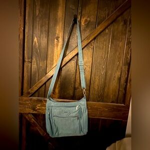 Travelon purse with anti-theft details, multiple pockets, and mini flashlight